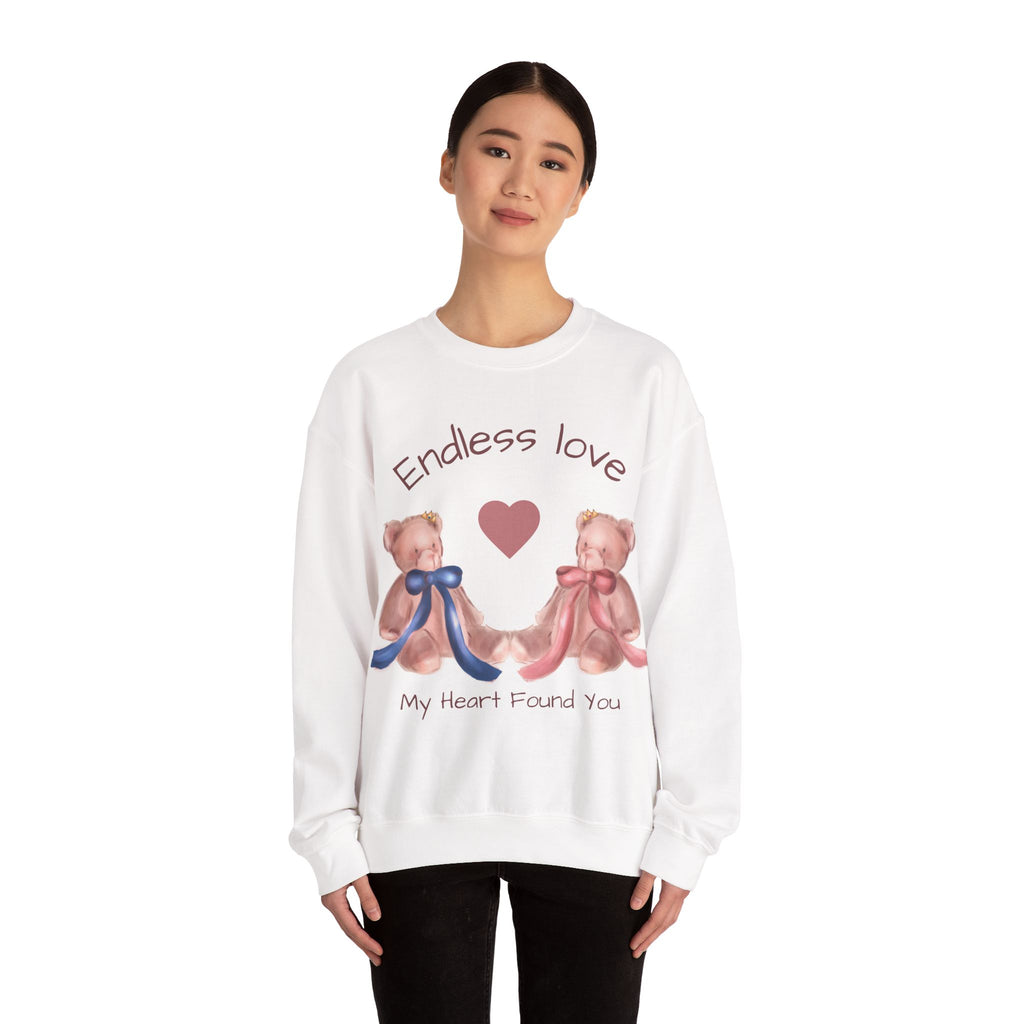 Person wearing a white sweatshirt with teddy bears and text on a white background
