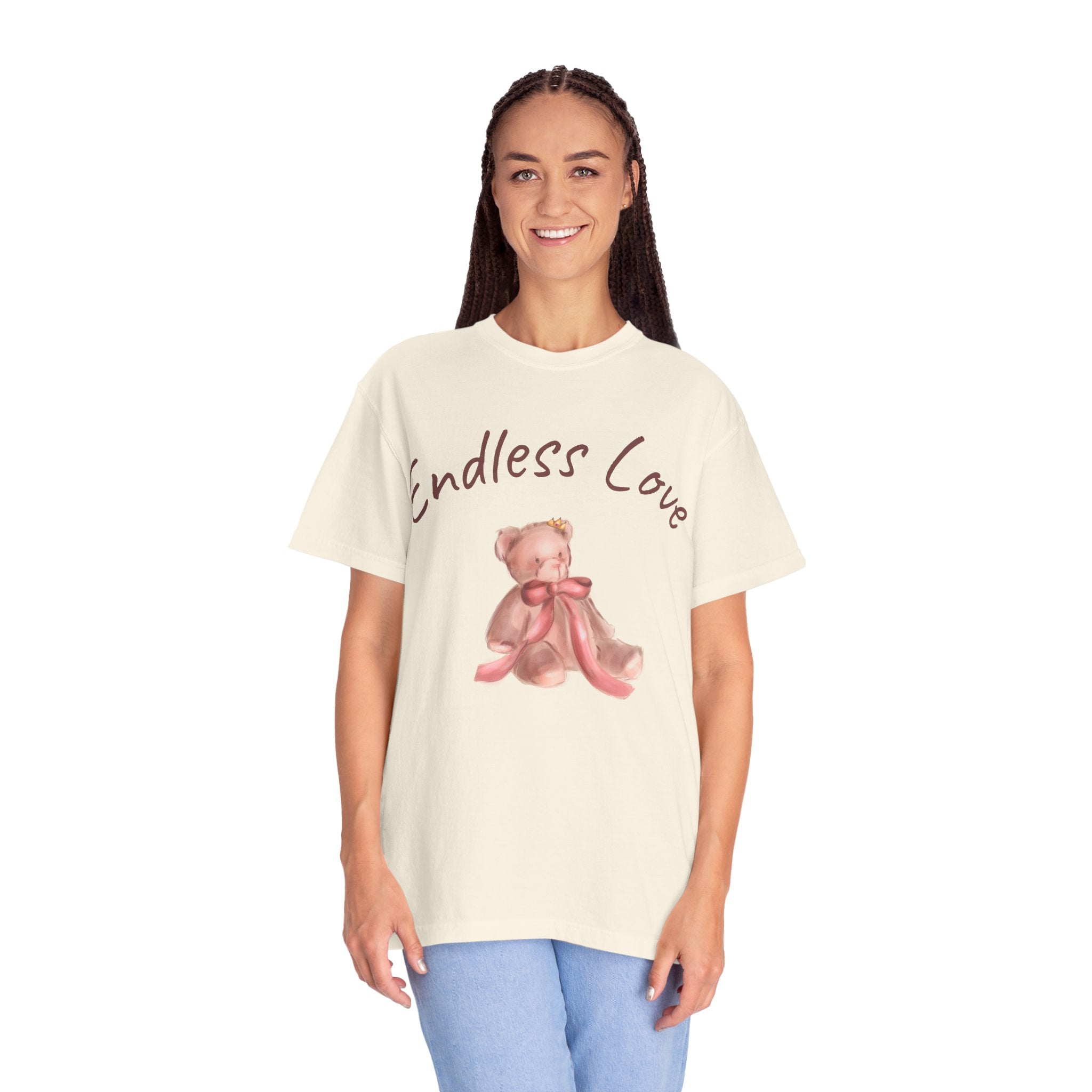 Woman wearing a cream t-shirt with a teddy bear graphic and 'Endless Love' text on a white background
