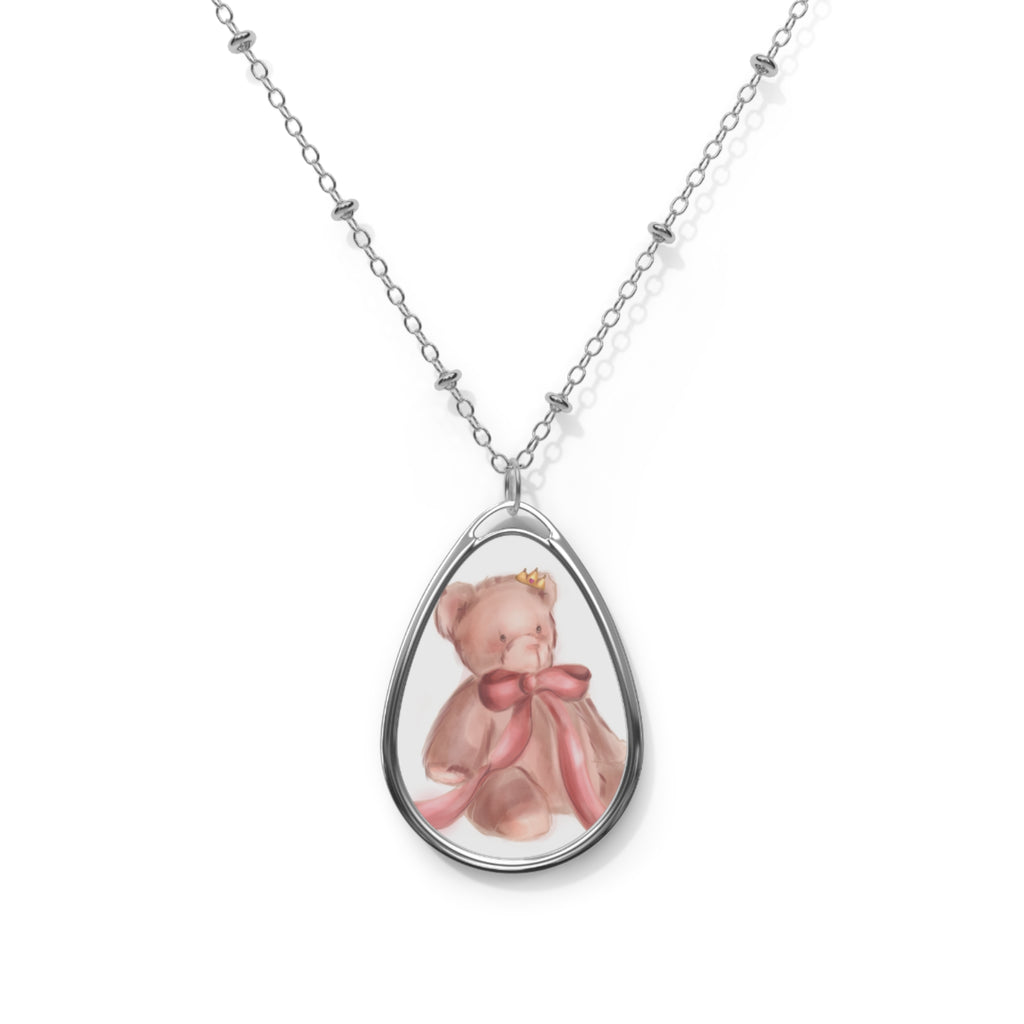 Teardrop-shaped pendant with a pink teddy bear design on a white background