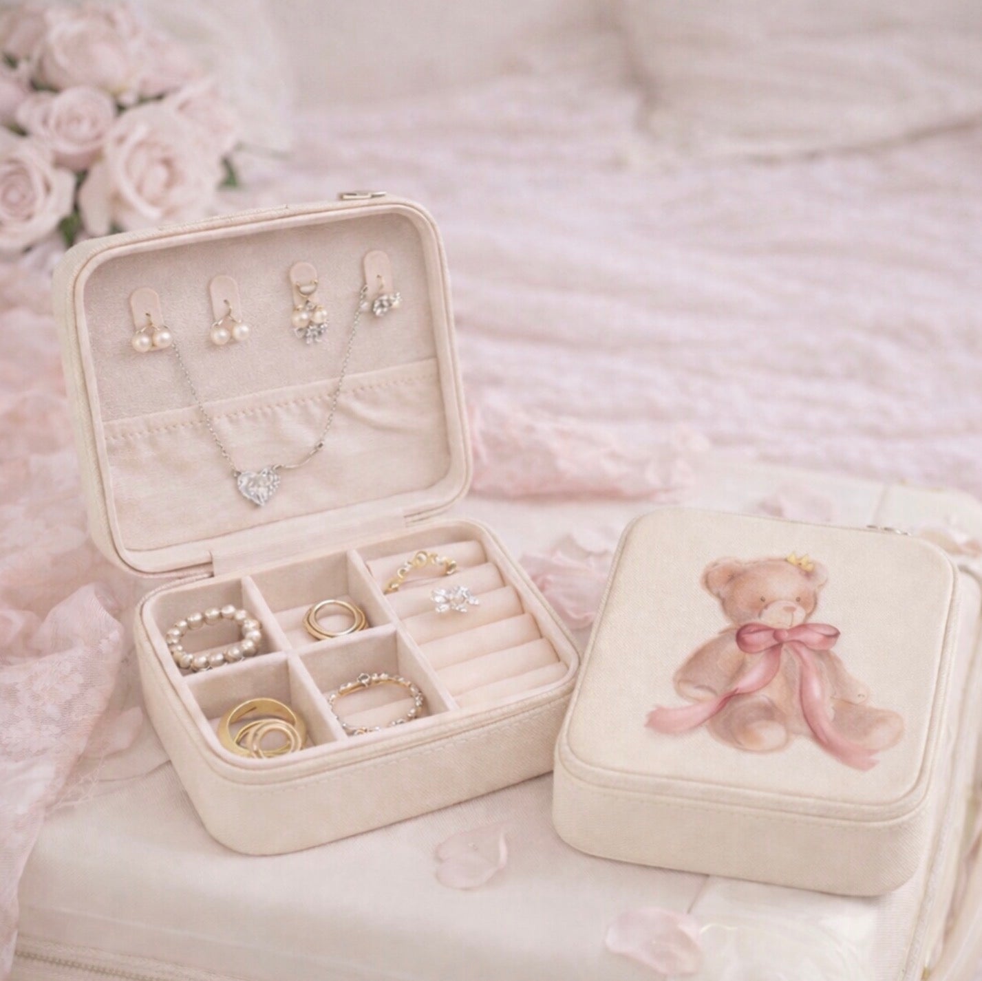 Jewelry box with jewelry and a teddy bear design on a soft pink background